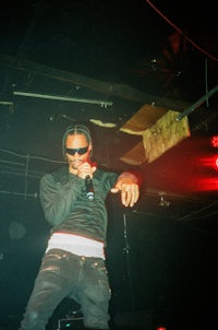 a man holding a microphone in a dark room