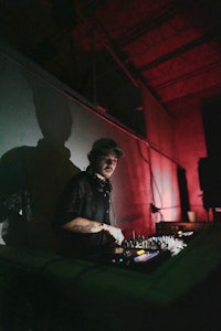 a dj playing music in a dark room